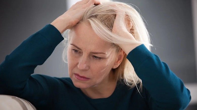 2023/02/mature-woman-head-ache-pain-sad.jpg