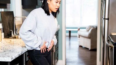 2024/01/A-young-woman-experiencing-pelvic-pain-grimacing.jpg