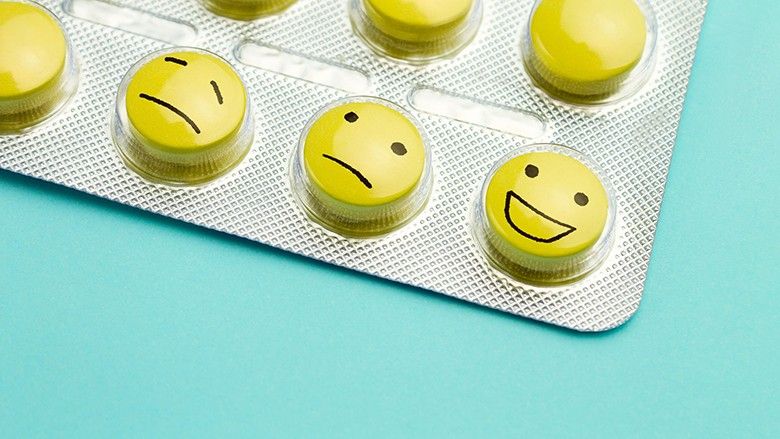 2024/02/yellow-pills-andfunny-faces-in-a-blister-on-a-blue-roy.jpg