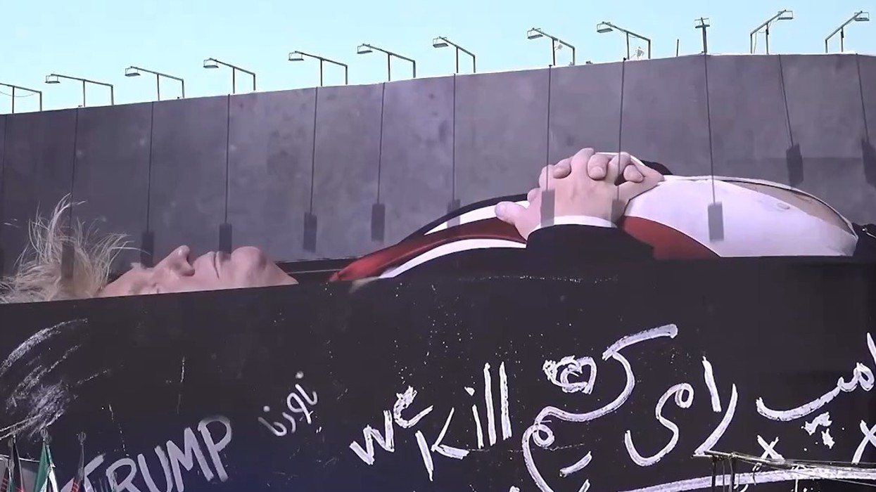 Banner in central Tehran, Trump appears in coffin with his family