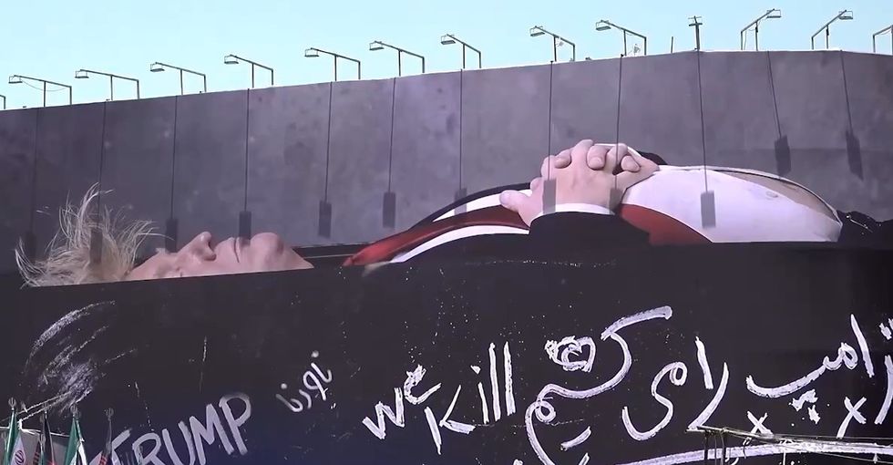 Banner in central Tehran, Trump appears in coffin with his family