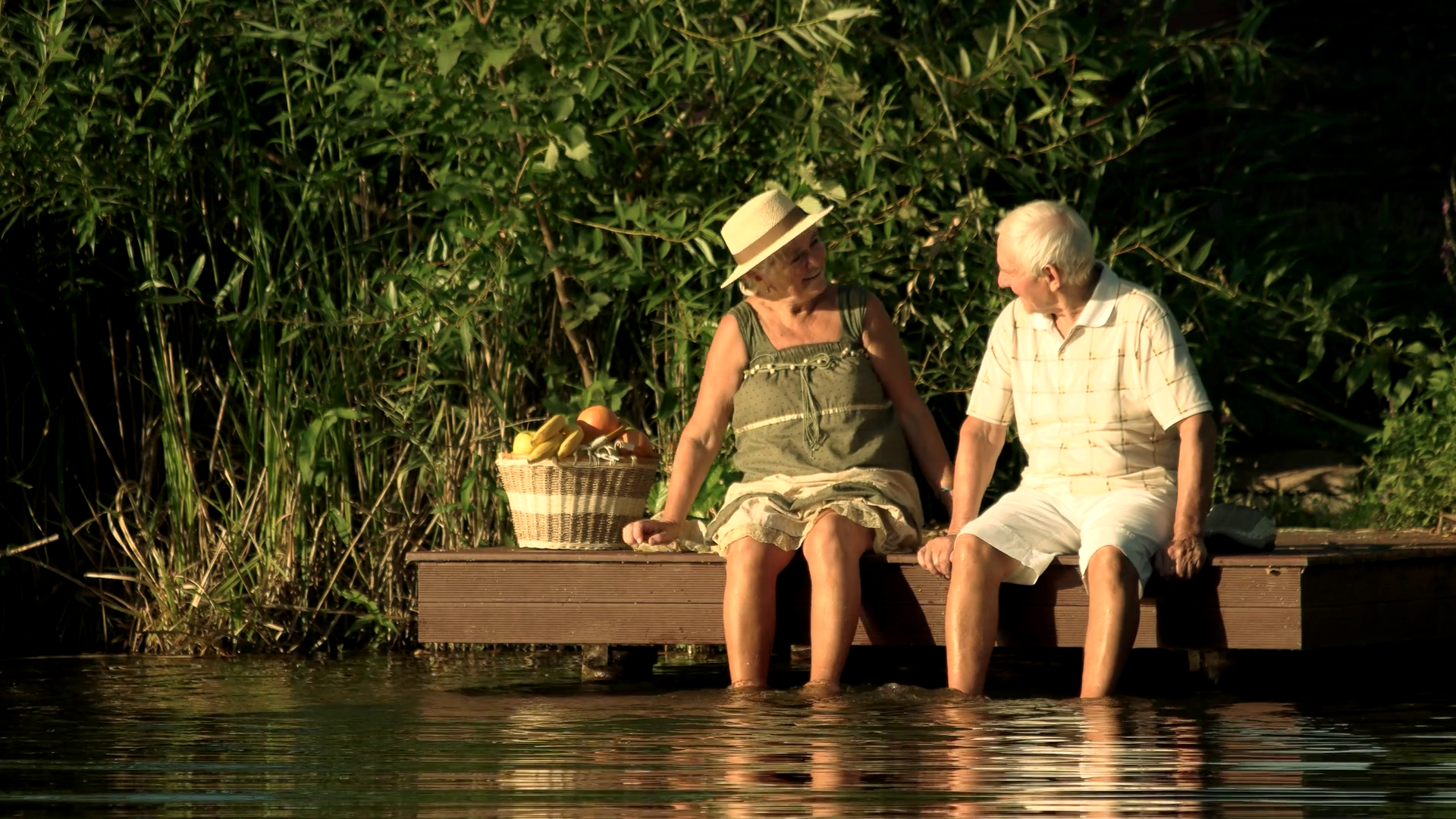 2019/08/videoblocks-senior-couple-sitting-near-water-happy-elderly-man-.png