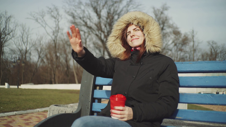 2020/01/videoblocks-portrait-smiling-young-woman-holding-cup-of-tea-or-coffee-and-drinking-outdoors-at-the-cold-sunny-.png