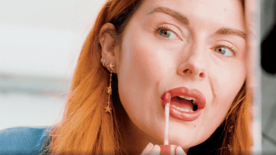 2023/02/videoblocks-young-woman-applying-liquid-lipstick-on-lips-close-u.png