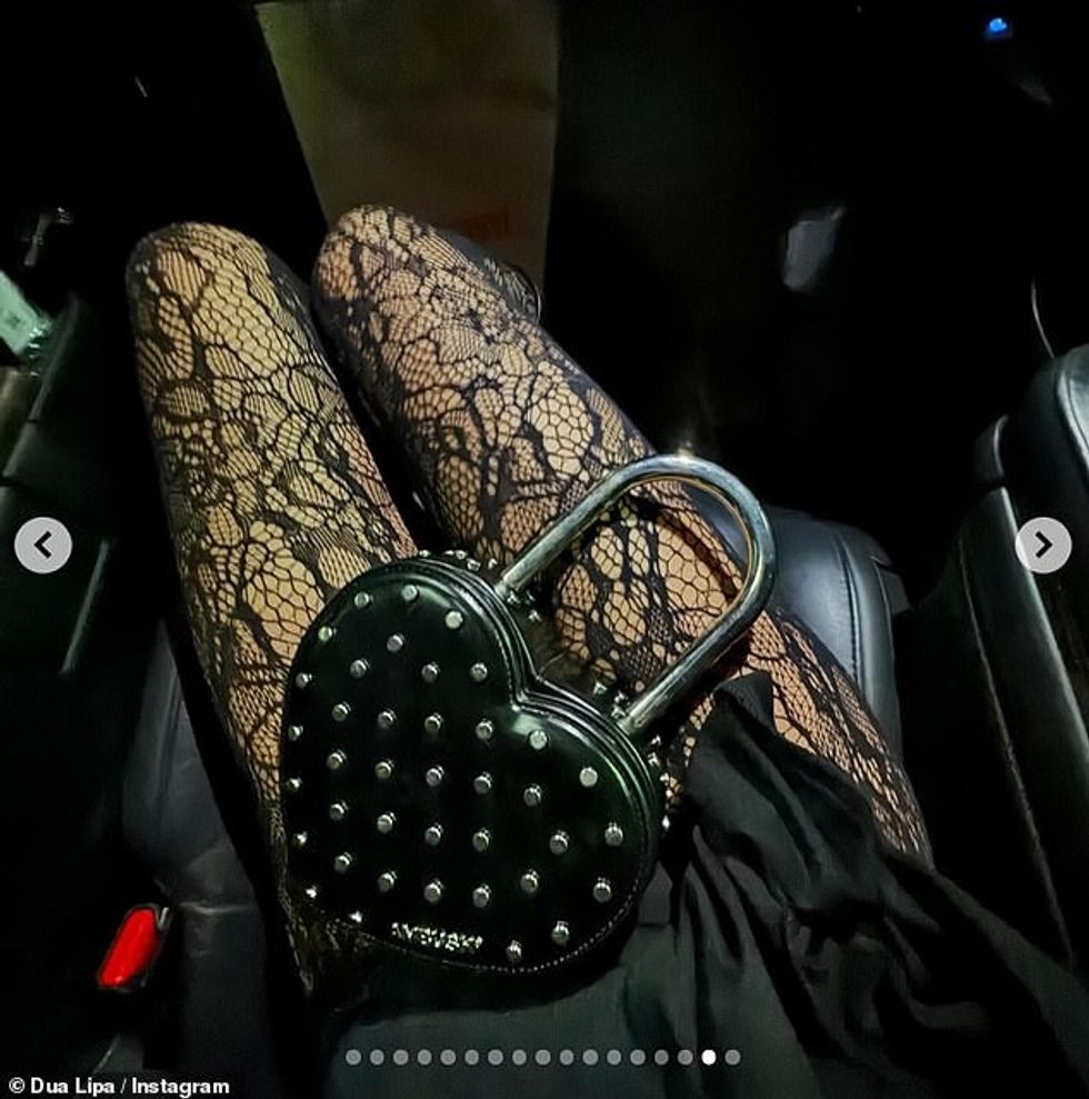 In one snap, she showed off her netted tights and studded heart purse that she had taken with her to explore the nightlife