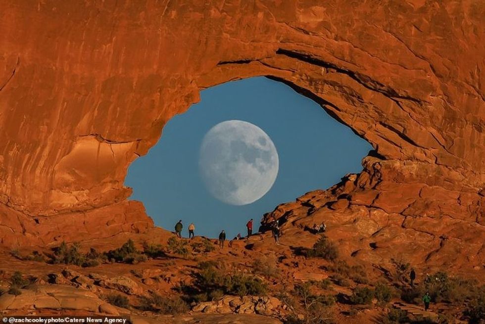 incredible photos show full moon looking like giant eye as it passes rock arch in utah1 1
