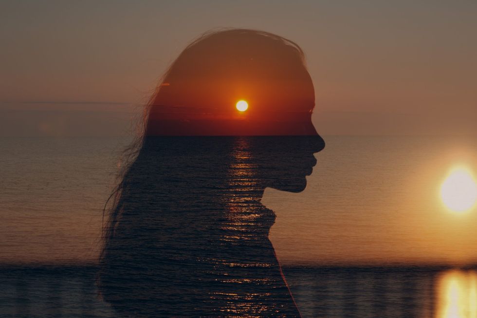 Intuition silhouette with sunset over water
