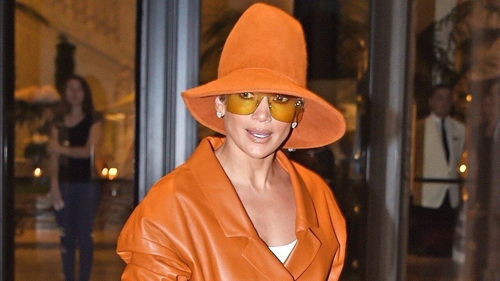 Jennifer Lopez stuns in an all orange ensemble while at MFW 1