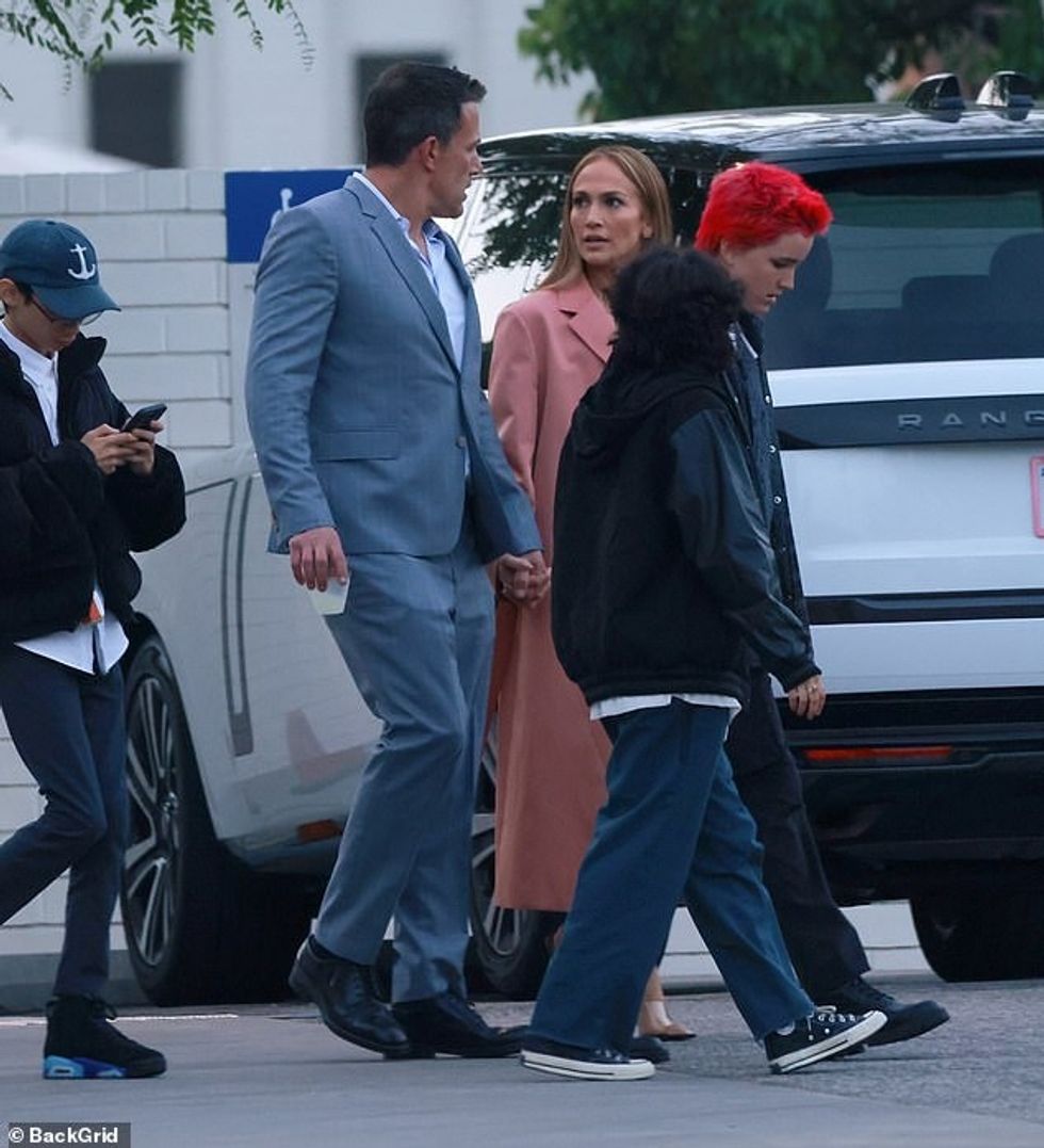 Jennifer veshi një pallto rozë salmon mbi fustanin e saj të ngjashëm