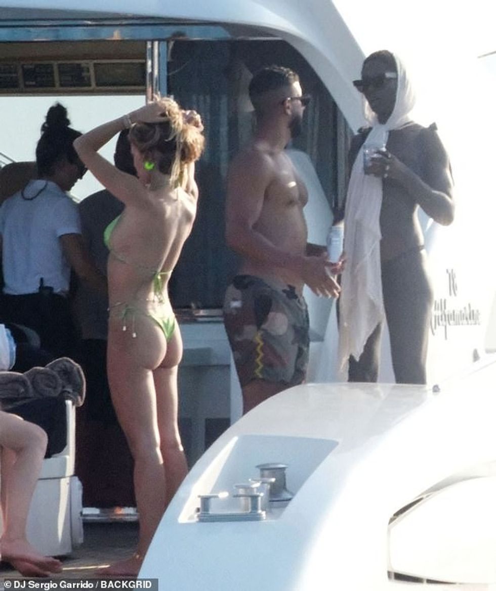 Jodie (R) showcased her jaw-dropping figure in a black bikini as she was spotted sipping on a cocktail