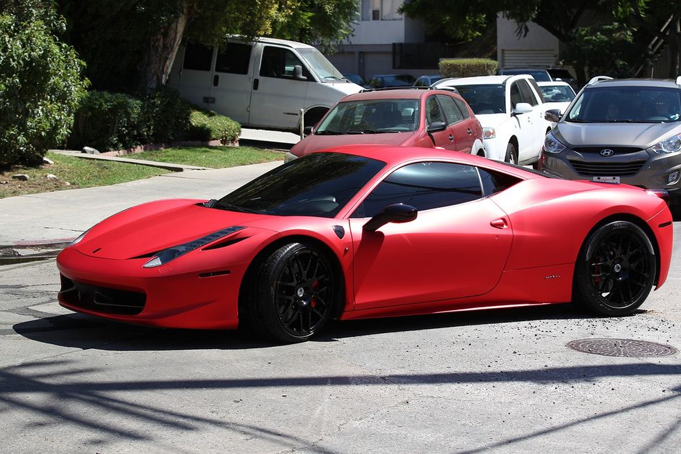 Justin Bieber driving his matte red Ferrari 458