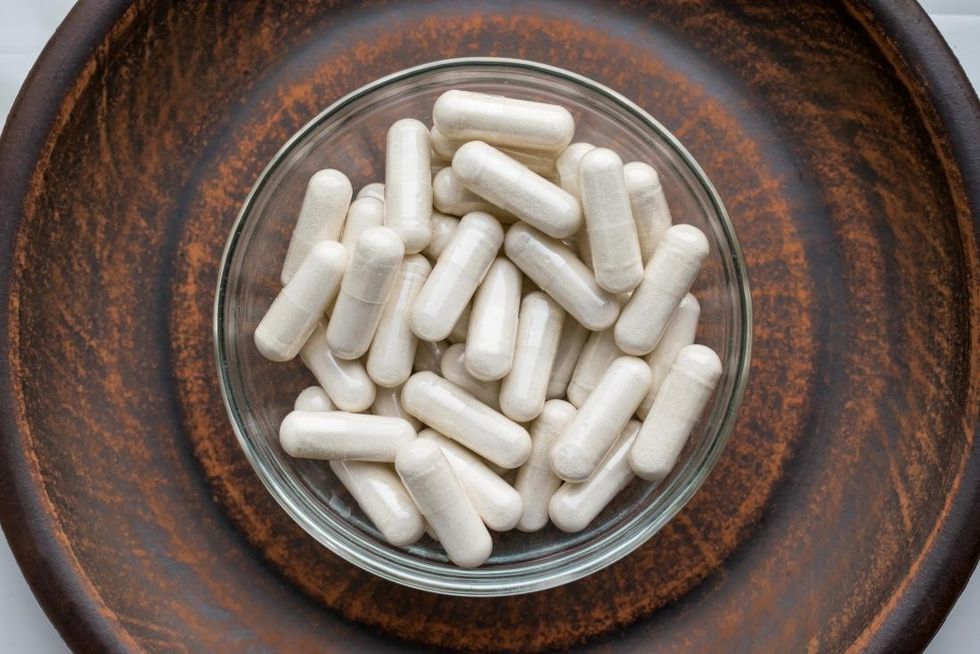 kava kava supplement capsules in bowl