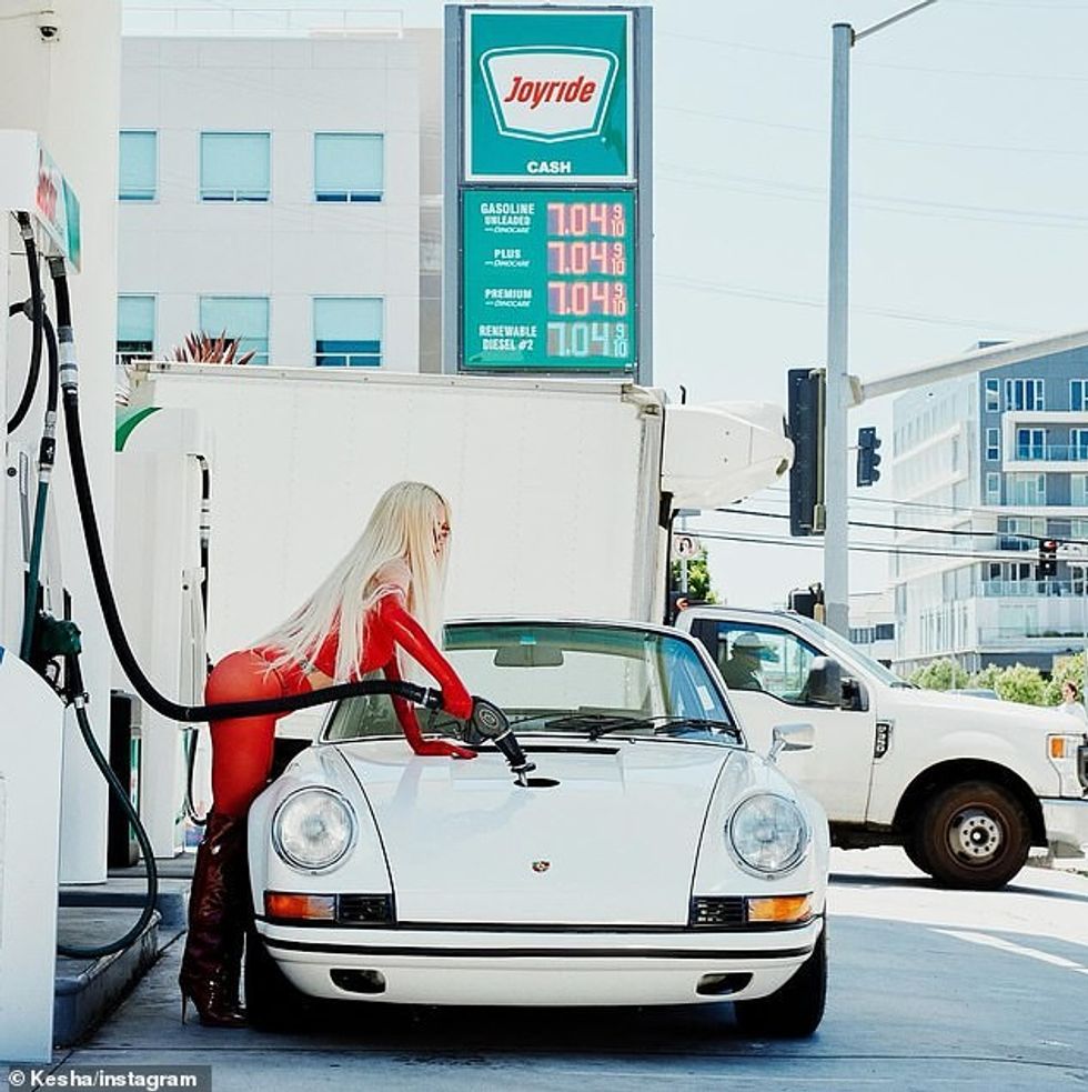 Kesha posed in a skintight red look as she pumped gas into a white sports car in a promotional shot for her new song Joyride