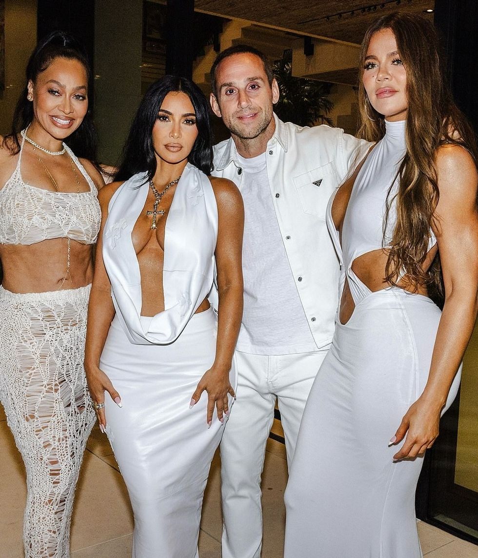 Kim Kardashian took the plunge in an angelic white ensemble at billionaire Michael Rubin's star-studded Fourth Of July party on Thursday. The reality TV star was seen posing with younger sister Khloe, 40, who had on a white gown with cut outs, and La La Anthony. Images of Kim were posted on Rubin's Instagram account (he is also pictured)