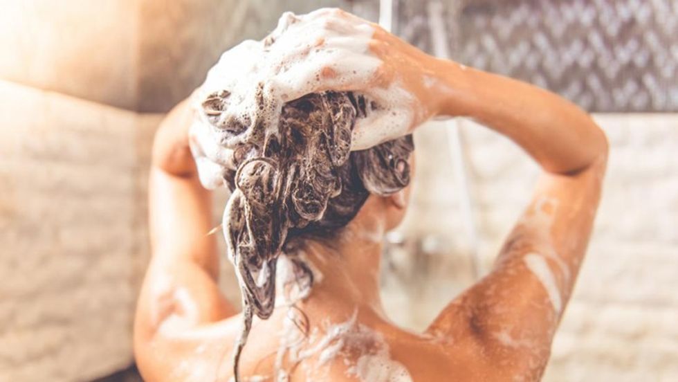 lady in a shower washing her hair