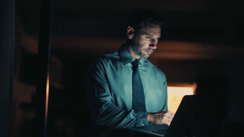 late night working man using laptop in th