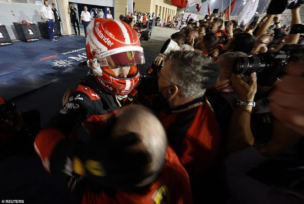 LeClerc celebrates with his mechanics after a tough race in which he won out in a hard battle with Max Verstappen who eventually retired