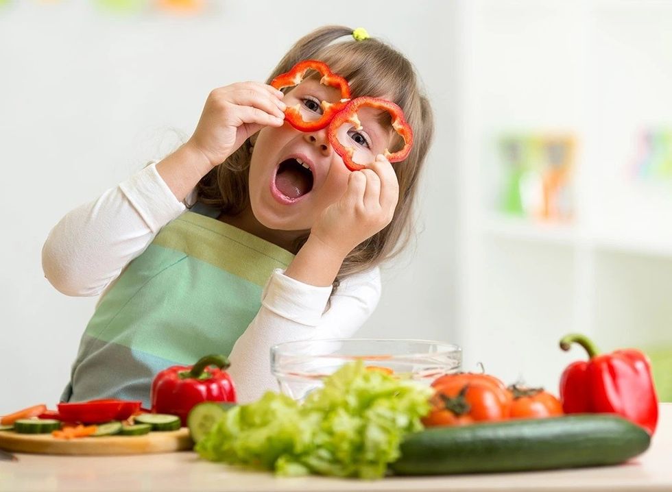 little girl playing veggies
