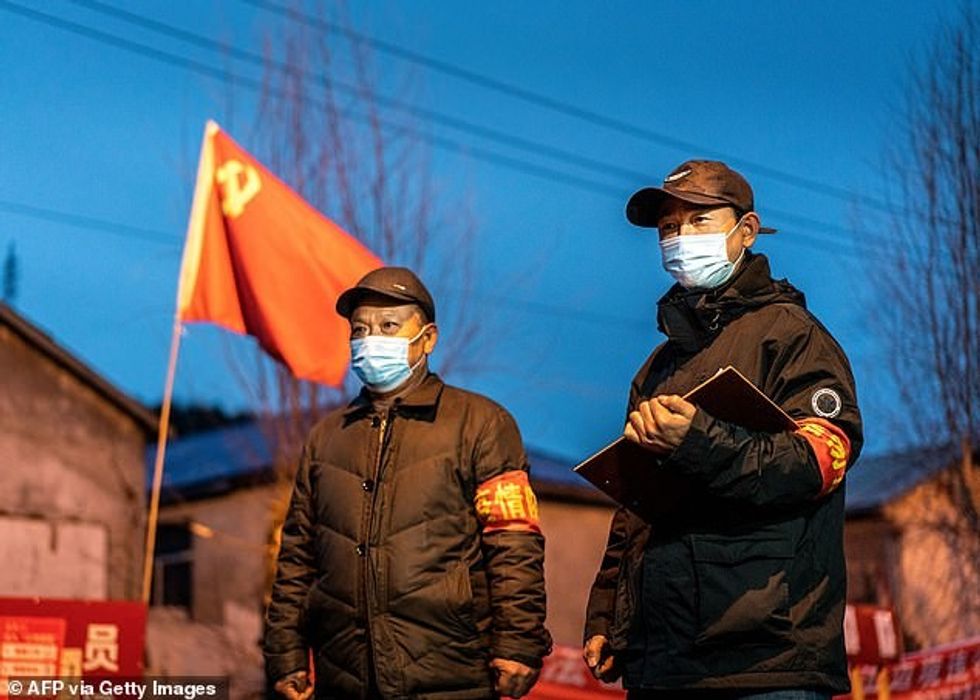 Local health authorities Tuesday reported the first two cases, a couple who contracted the killer bug from an unknown source. This file picture taken on April 21 shows staff members keeping watch at a checkpoint in Suifenhe of China's north-eastern Heilongjiang province