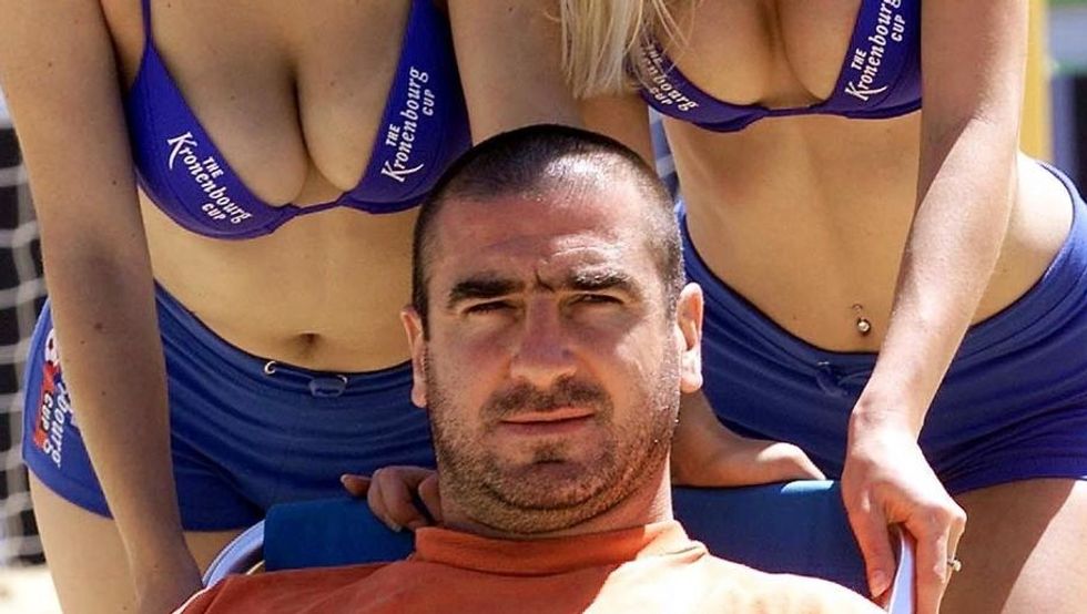 LONDON, UNITED KINGDOM - JUNE 22: French international Eric Cantona kicks off the British leg of the Kronenburg beach football cup in Hyde park in Central London 22 June 2001. The tournament runs for three days with teams from England, France, Switzerland and Spain. (Photo credit should read HUGO PHILPOTT/AFP/Getty Images)