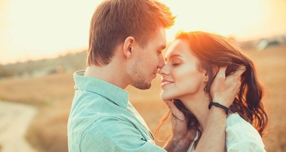 man and woman trying to kiss each other