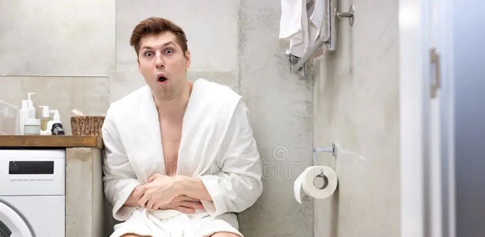 man bathrobe suffering stomach ache toilet bowl bathroom ma edited