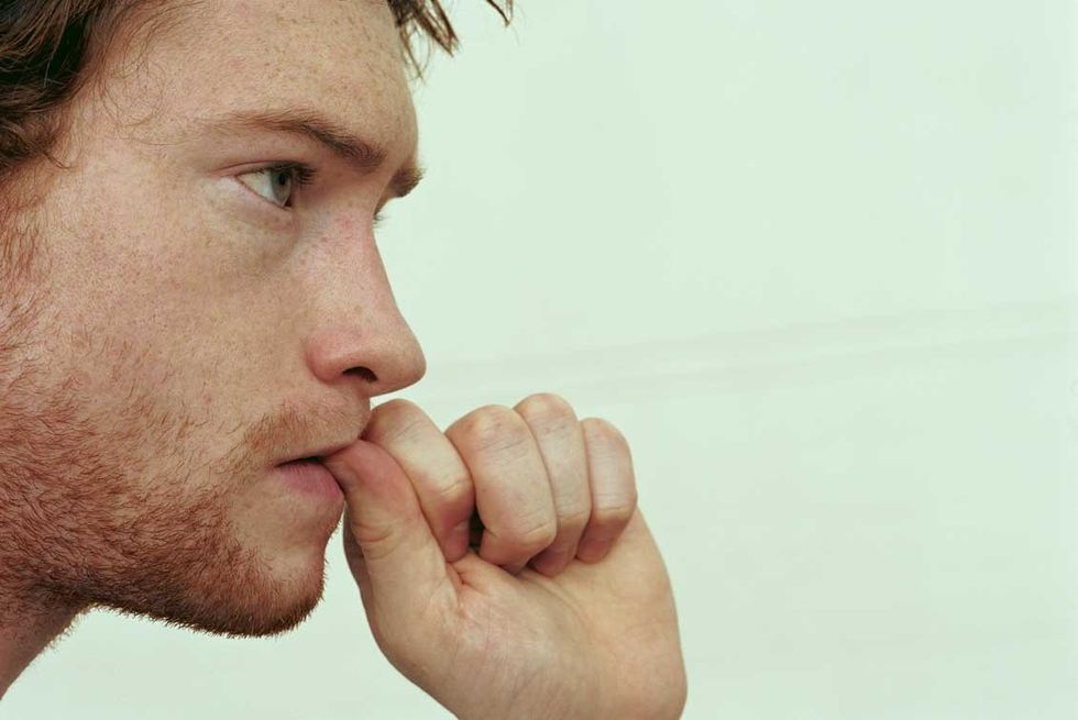 man biting nails