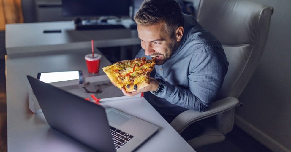 Man eating pizza at night 1