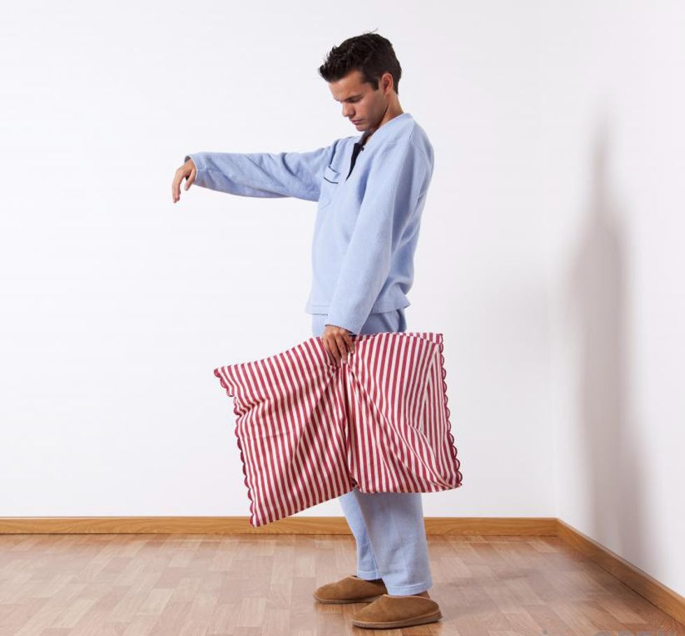 man in pajamas sleepwalking wit
