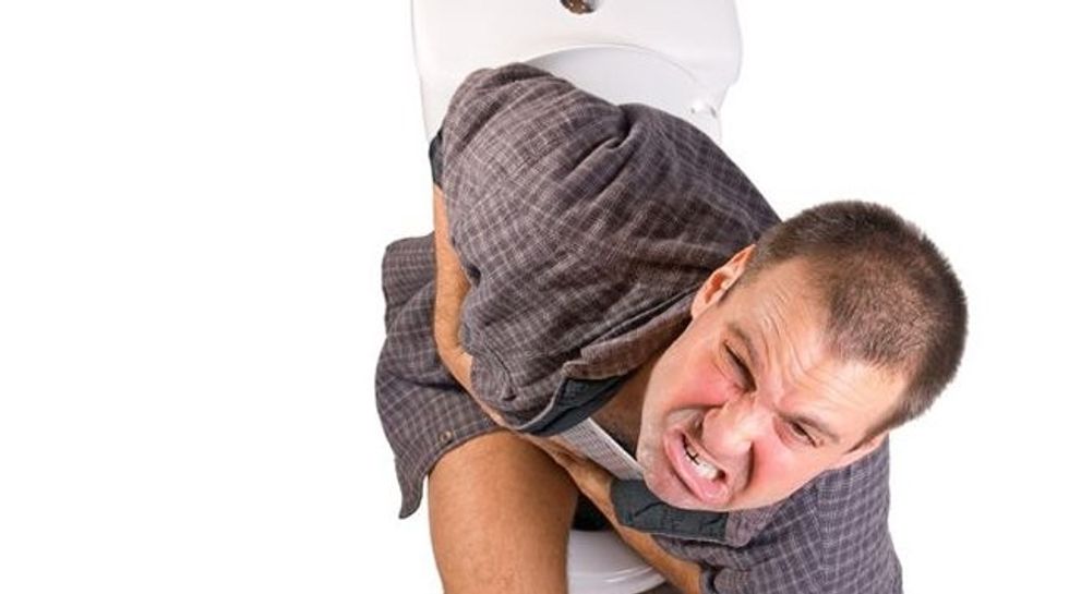 man on toilet grimacing in pain IBS Pain and Cramping