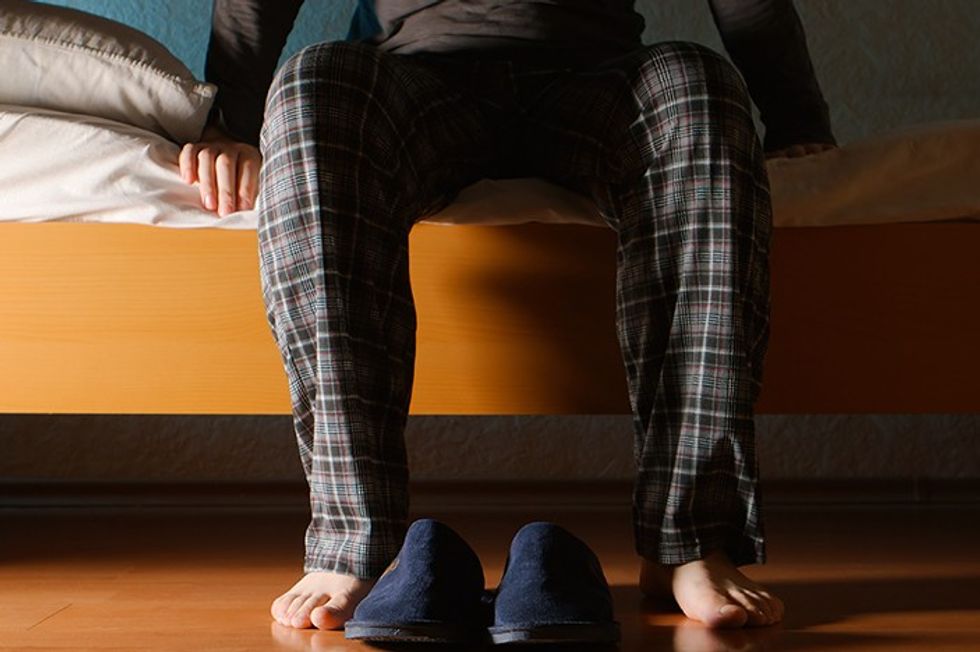 man sitting on exam table talking to doctor