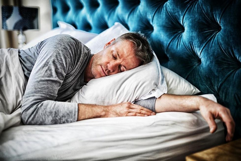 man sleeping on bed in bedroom1