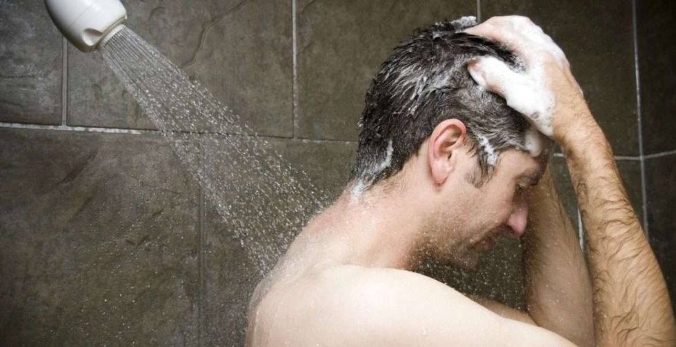 man using shampoo in the shower 1