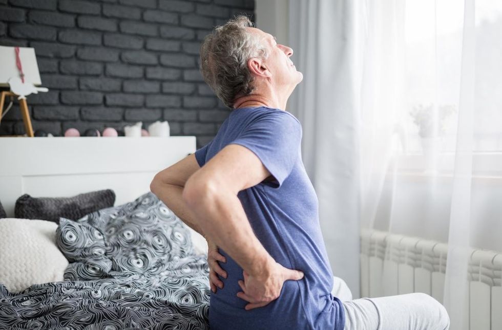 man waking up with lower back pain