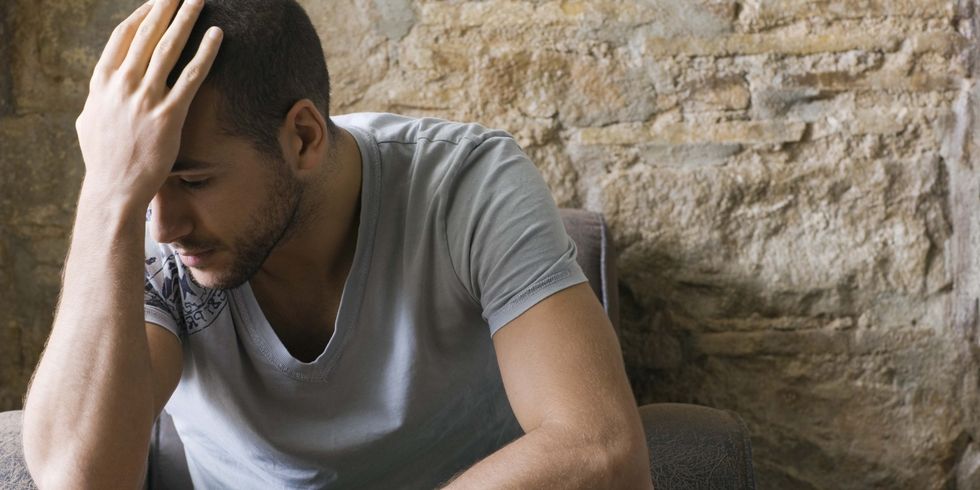 Man with hand on head