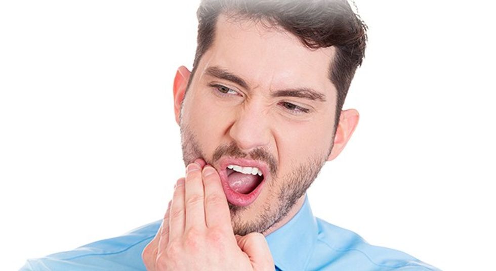 man with wisdom tooth pain
