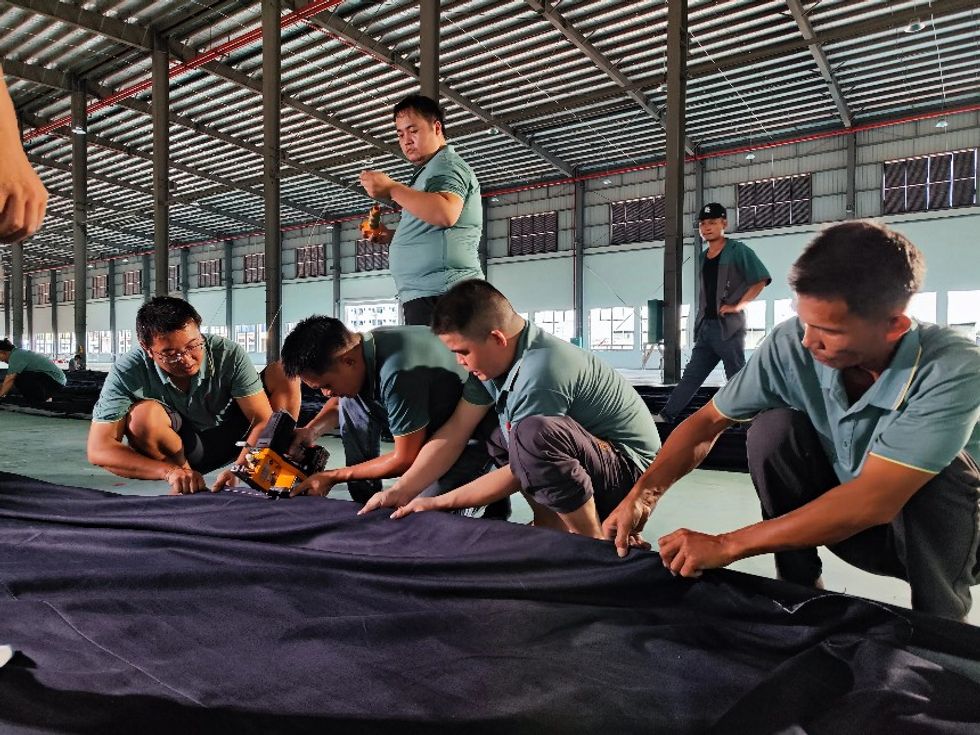many worker working on the details of the jeans