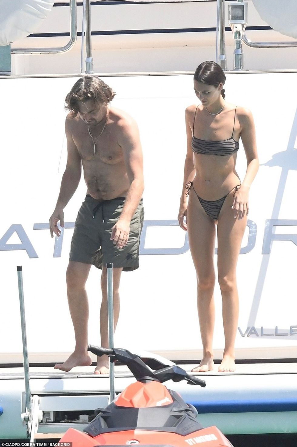 Me një rroba banje të gjelbër ushtarake që nxirrte në pah fizikun e tij të tonifikuar në palestër, ylli i pashëm dukej i gëzuar teksa pushonin në një jaht luksoz.