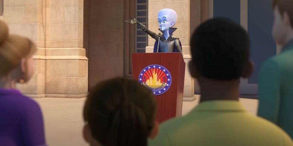 Megamind duke folur në një podium në Megamind vs the Doom Syndicate.