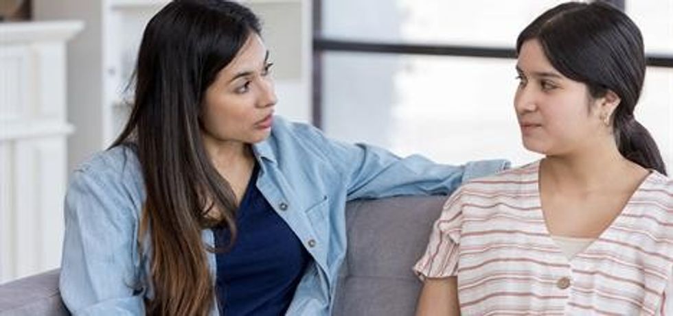 mid adult mom has important conversation with teen daughter