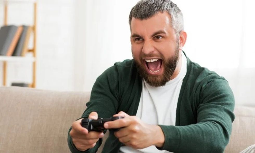middleaged man playing video games at home picture 768