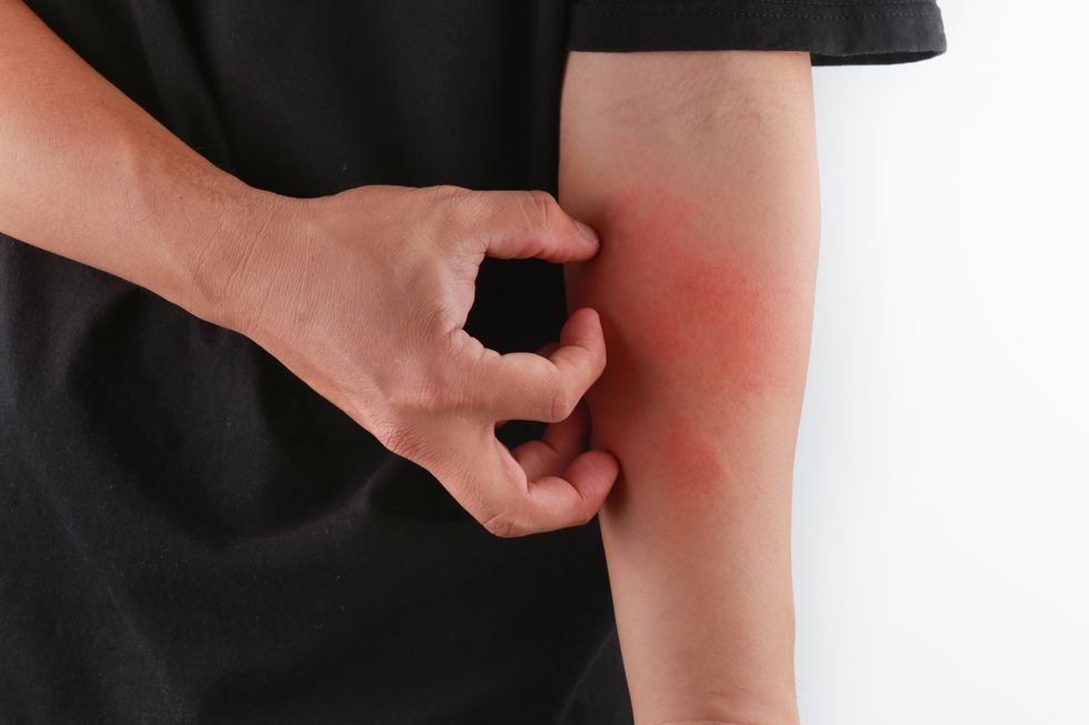 midsection of man scratching while standing against royalty free image 903999812 1548870860