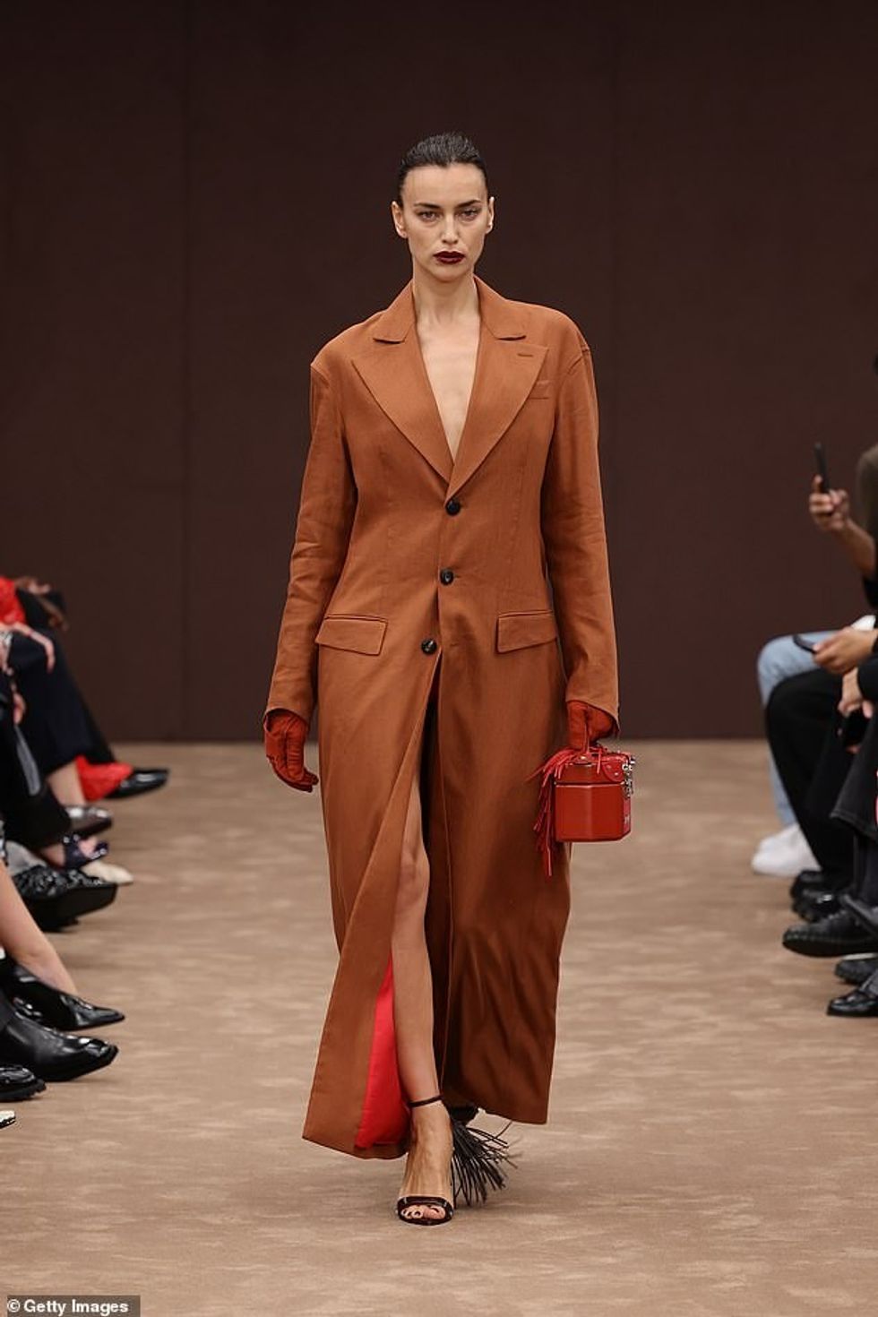 Modelja ruse, Irina, 38 vjeçe, dukej sensacionale teksa u fut pa sytjena nën një pallto të nxirë me gjarpërim, teksa vidhte veten.