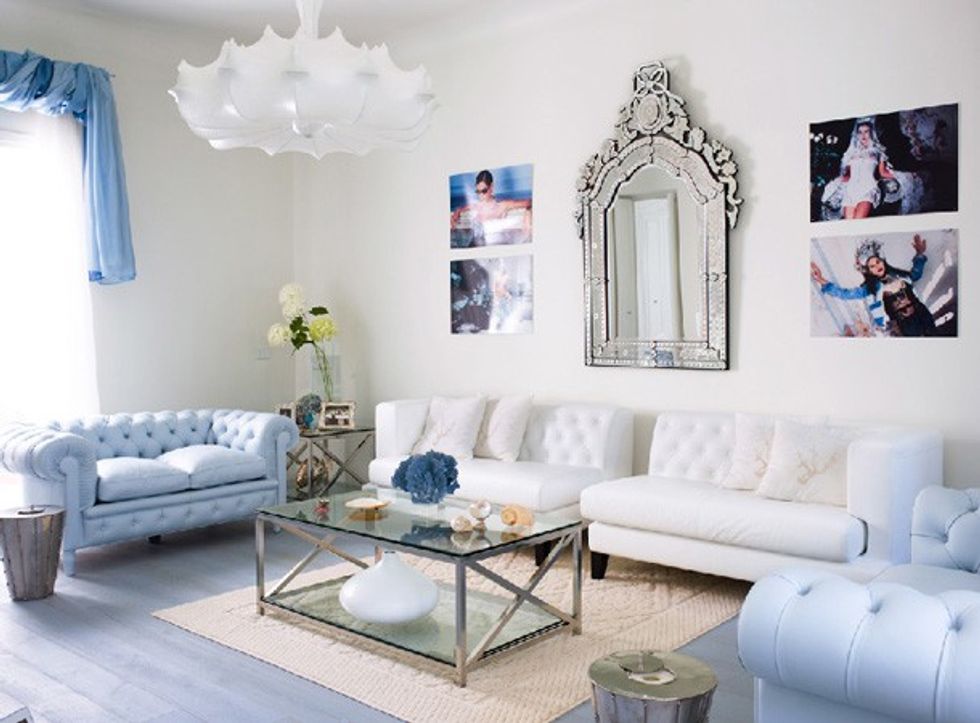 modern chic blue and white living room with chandelier