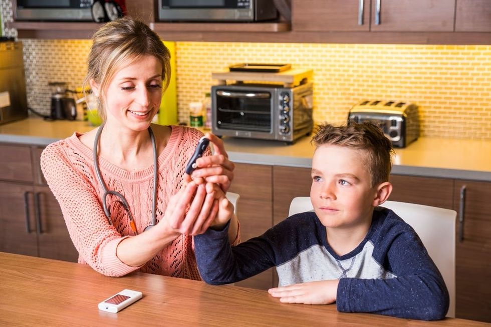 Mom Boy blood glucose test finger