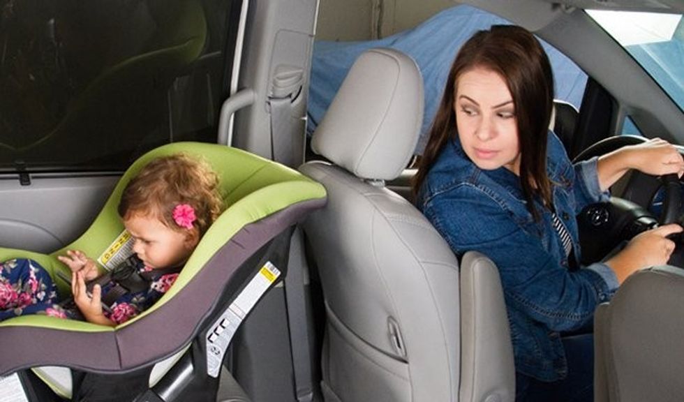 Mom looking back at rear facing child in car seat