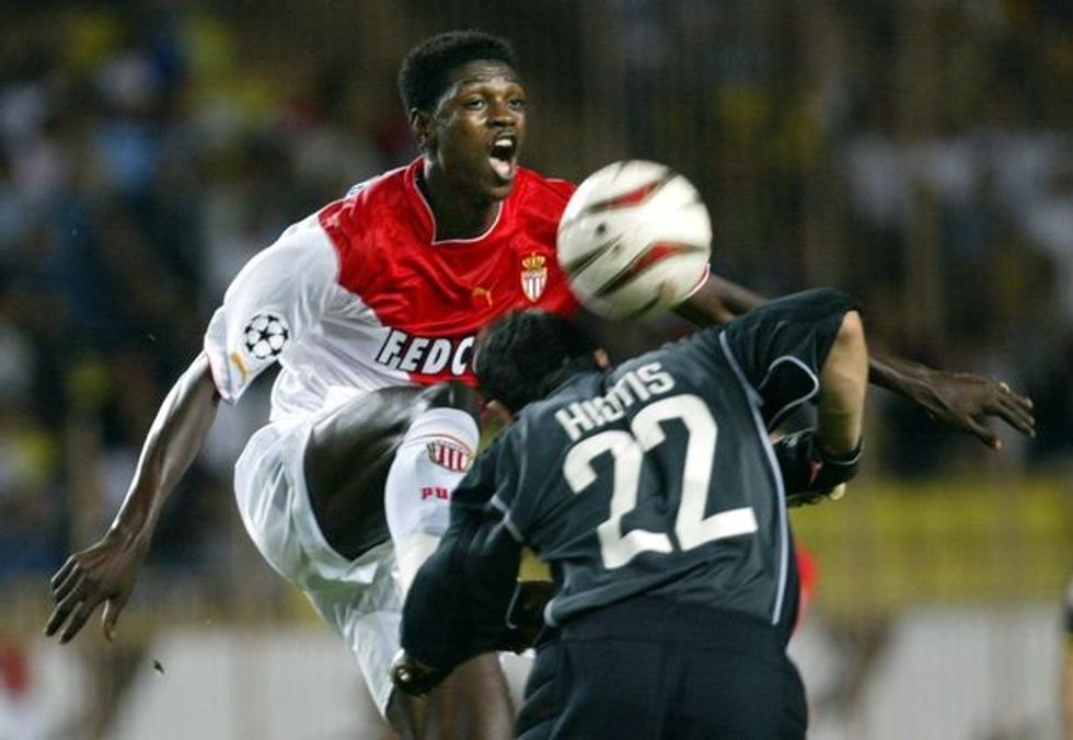 MONACOS EMMANUEL ADEBAYOR CHALLENGES ATHENS GOALKEEPER DURING CHAMPIONS LEAGUE IN MONACO