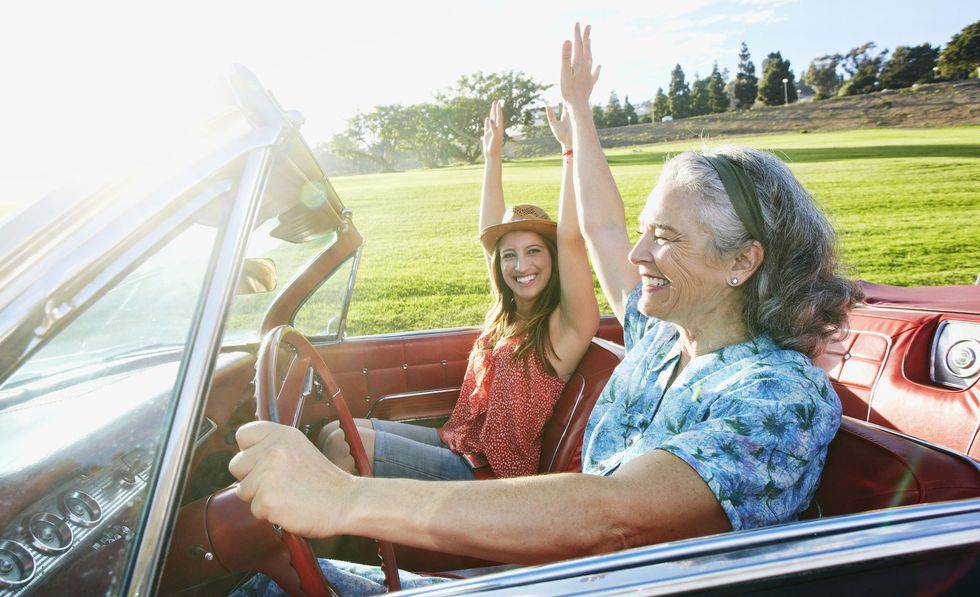 mother and daughter driving in classic convertible royalty free image 533766347 1556827165