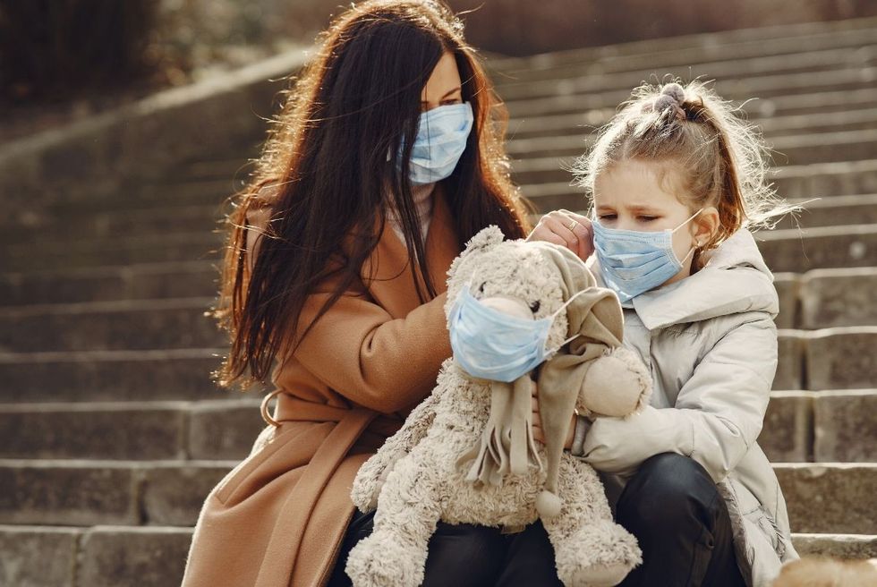 mother and daughter wearing face masks
