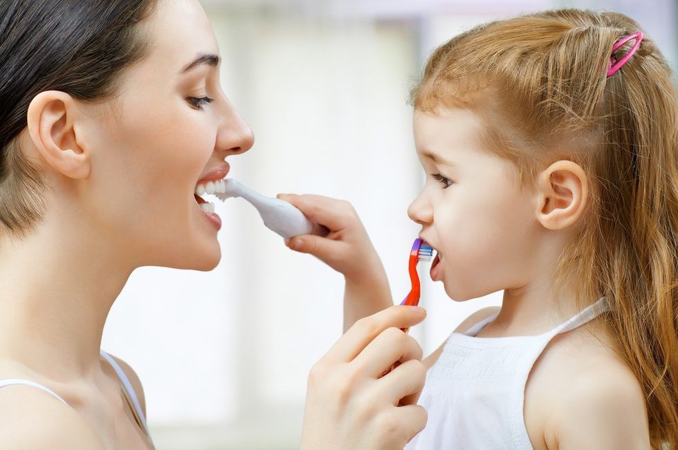 mother daughter brushing teeth 1